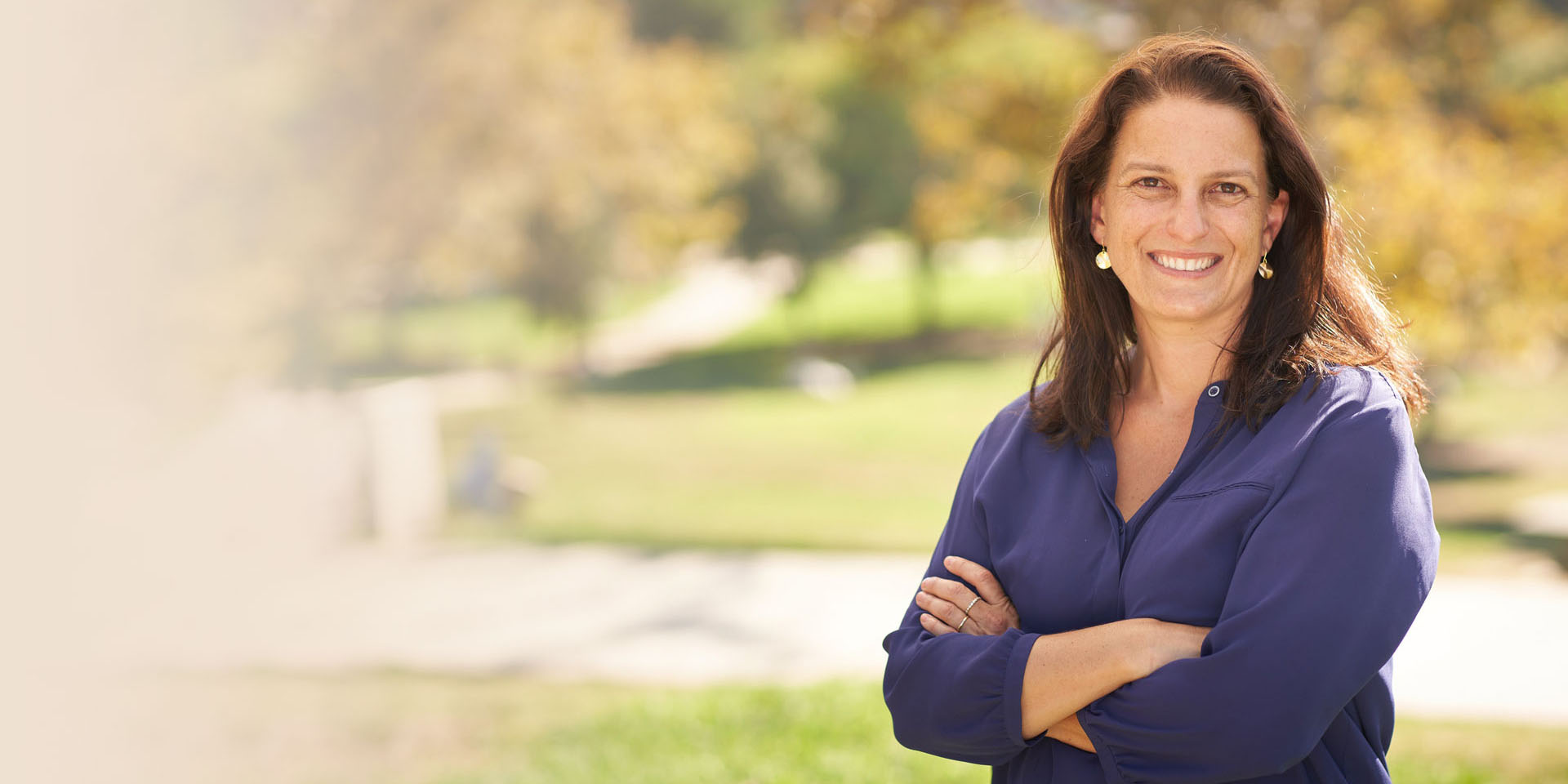 Councilmember Katy Yaroslavsky stands with her arms folded across her chest outdoors in District 5.